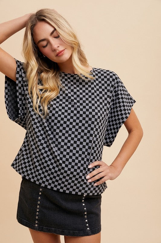 The Checkered Round Neck Short Sleeve T-Shirt is a casual and chic staple for your wardrobe. The checkered pattern adds a trendy and modern touch to the classic design.
