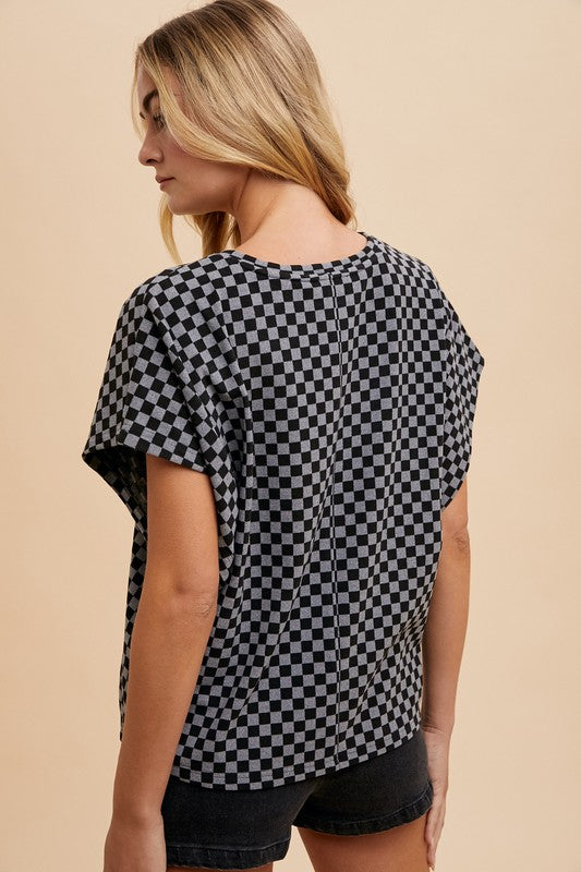 The Checkered Round Neck Short Sleeve T-Shirt is a casual and chic staple for your wardrobe. The checkered pattern adds a trendy and modern touch to the classic design.