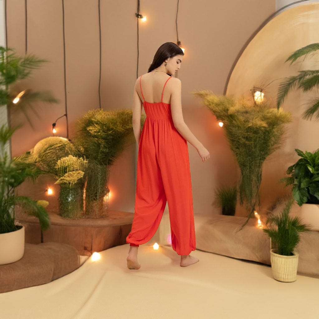 This vibrant orange V-neck jumpsuit is the perfect addition to your summer and spring wardrobe. Its spaghetti straps and lightweight fabric make it ideal for trips and traveling, whether on vacation or just running errands.